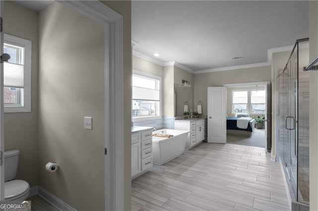 bathroom with a shower stall, visible vents, toilet, vanity, and crown molding