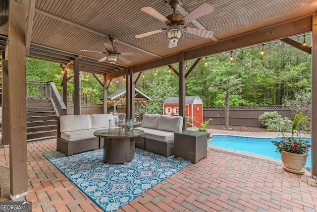1985 Chapel Estates Ln, Dacula, GA 30019 - fenced backyard featuring an outdoor living space, a patio area, ceiling fan, a storage shed, and stairs