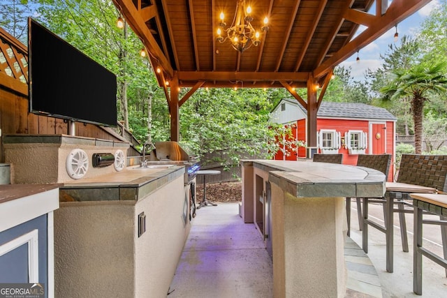1985 Chapel Estates Ln, Dacula, GA 30019 - view of patio / terrace featuring an outdoor kitchen and an outbuilding