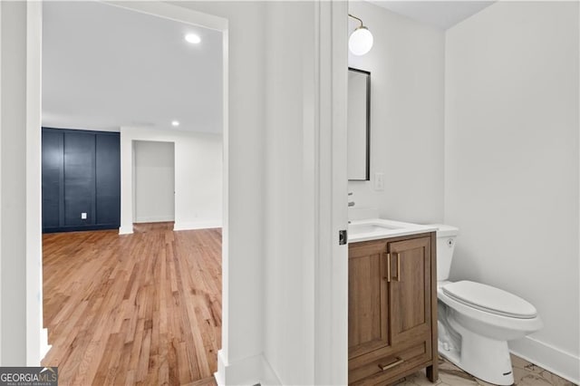 1835 Hawkins St, Smyrna, GA 30080 - bathroom with toilet, wood finished floors, vanity, baseboards, and recessed lighting