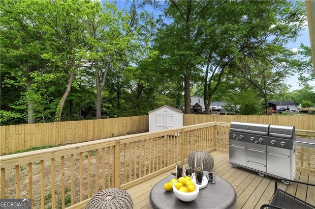 1835 Hawkins St, Smyrna, GA 30080 - wooden terrace with grilling area, a fenced backyard, a storage unit, and an outbuilding