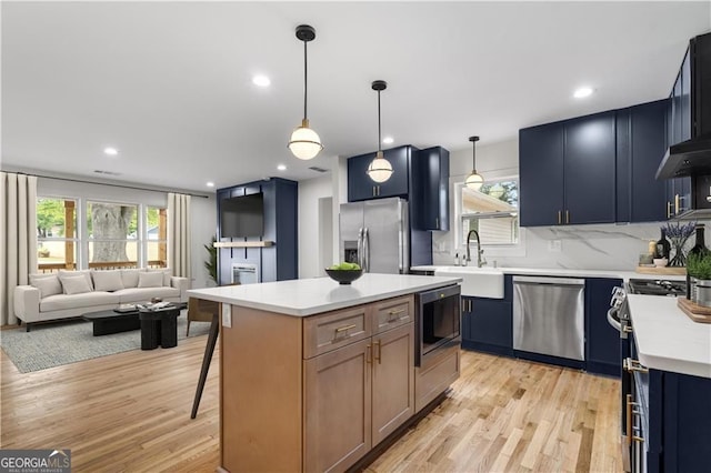 1835 Hawkins St, Smyrna, GA 30080 - kitchen with stainless steel appliances, light wood-style flooring, a sink, backsplash, and light countertops