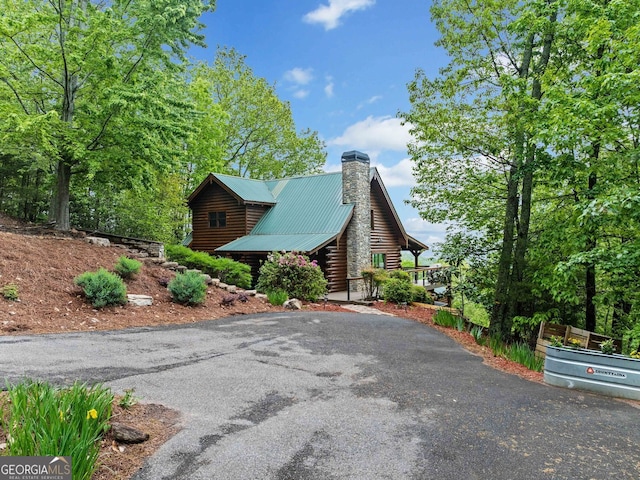 399 Ranch Mountain Dr, Dahlonega, GA 30533 - view of side of home with log exterior, a chimney, driveway, and metal roof