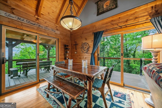399 Ranch Mountain Dr, Dahlonega, GA 30533 - dining room featuring beam ceiling, wood walls, a healthy amount of sunlight, and hardwood / wood-style flooring