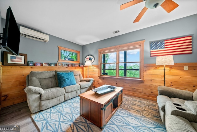 399 Ranch Mountain Dr, Dahlonega, GA 30533 - living room with visible vents, a wall mounted air conditioner, wooden walls, a wainscoted wall, and a ceiling fan