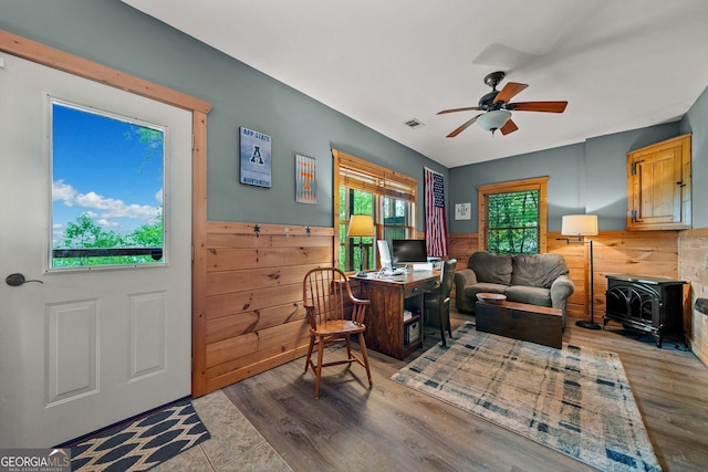 399 Ranch Mountain Dr, Dahlonega, GA 30533 - office featuring ceiling fan, visible vents, a wood stove, wood finished floors, and a wainscoted wall