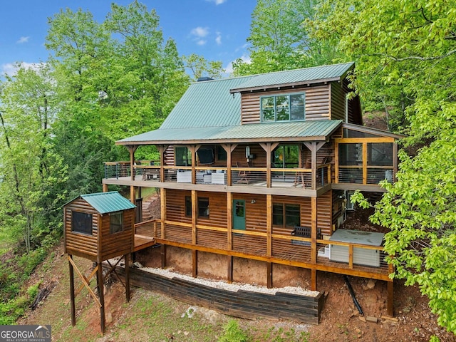 399 Ranch Mountain Dr, Dahlonega, GA 30533 - rear view of property with metal roof, a sunroom, and a wooden deck
