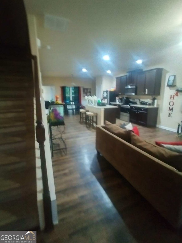 living room with recessed lighting and dark wood finished floors