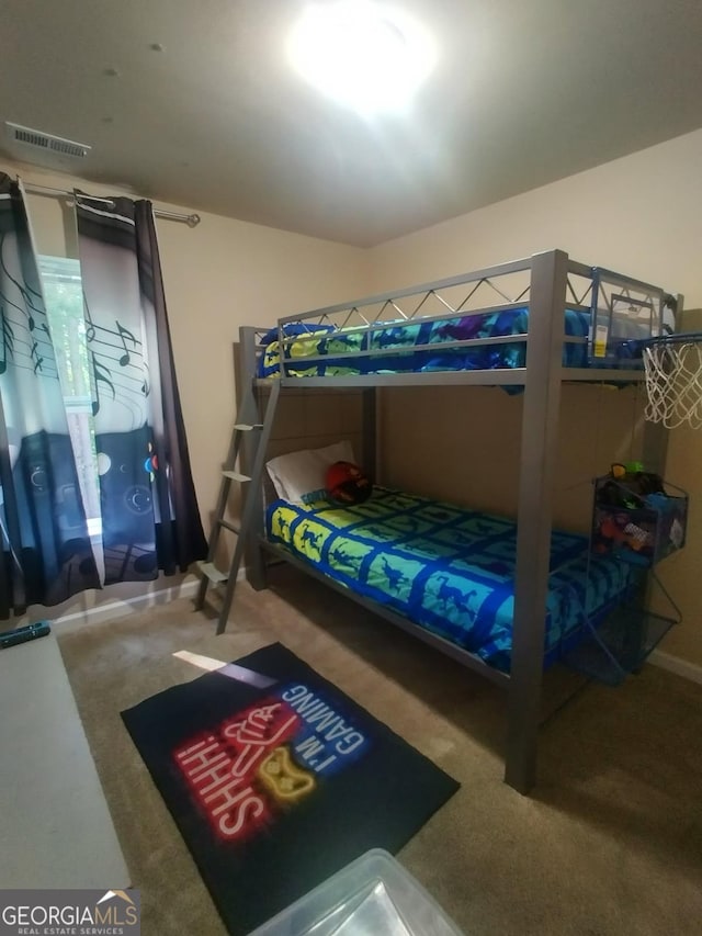 carpeted bedroom featuring visible vents