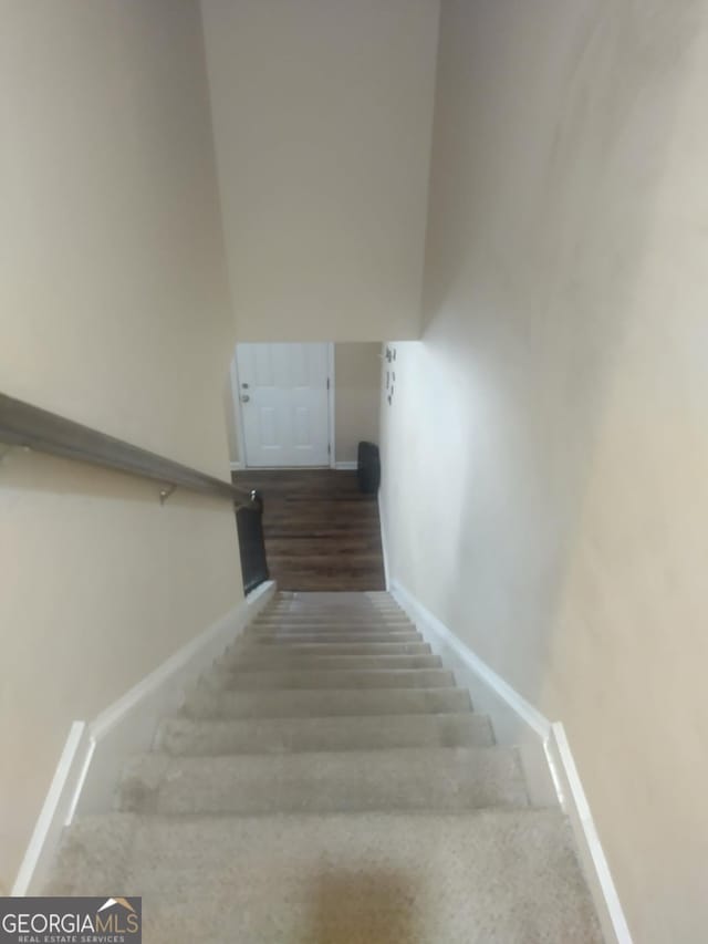 stairs featuring baseboards and carpet floors