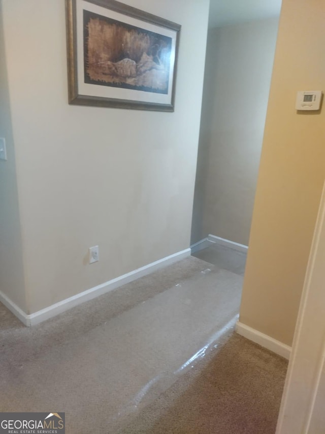 interior space featuring carpet floors and baseboards