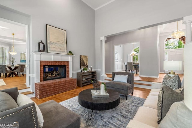 500 Meadowmeade Ln, Lawrenceville, GA 30043 - living room featuring decorative columns, healthy amount of natural light, wood finished floors, and a high ceiling