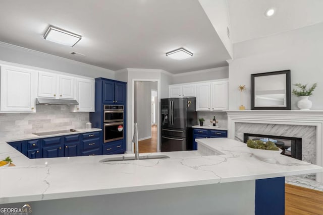 500 Meadowmeade Ln, Lawrenceville, GA 30043 - kitchen featuring refrigerator with ice dispenser, blue cabinets, stainless steel double oven, black electric cooktop, and ornamental molding