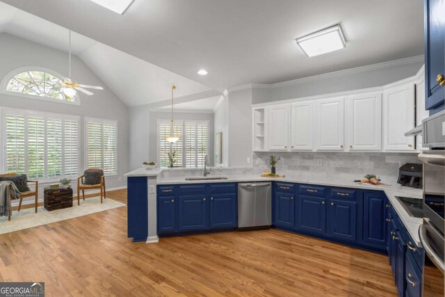 500 Meadowmeade Ln, Lawrenceville, GA 30043 - kitchen with stainless steel dishwasher, blue cabinets, ceiling fan, vaulted ceiling, and white cabinetry