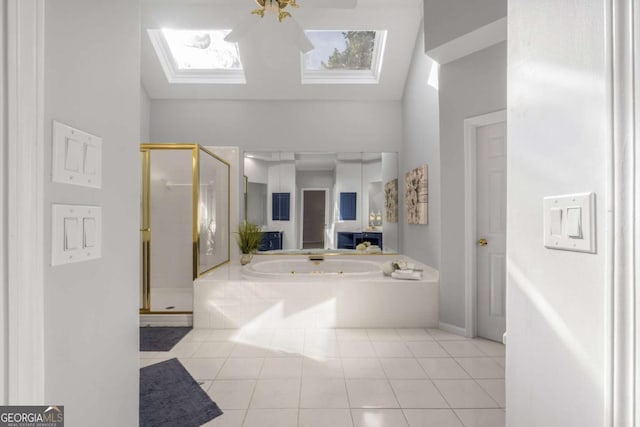 500 Meadowmeade Ln, Lawrenceville, GA 30043 - full bath featuring a skylight, a stall shower, a jetted tub, tile patterned flooring, and lofted ceiling