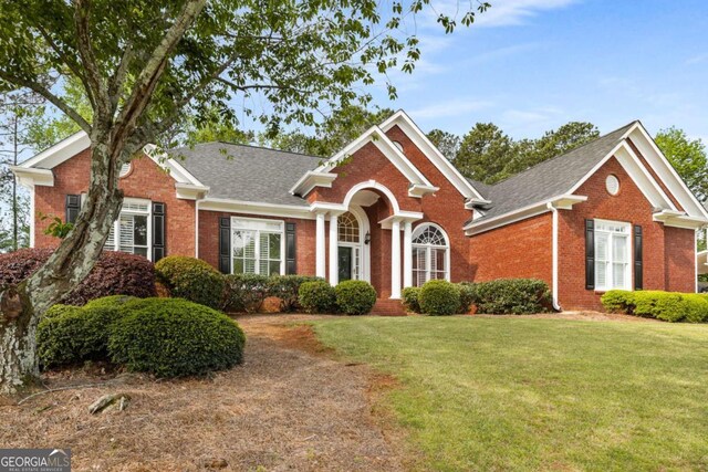 500 Meadowmeade Ln, Lawrenceville, GA 30043 - view of front of home featuring brick siding, a front yard, and a shingled roof