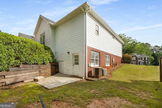 500 Meadowmeade Ln, Lawrenceville, GA 30043 - rear view of property with a patio area, a yard, and brick siding