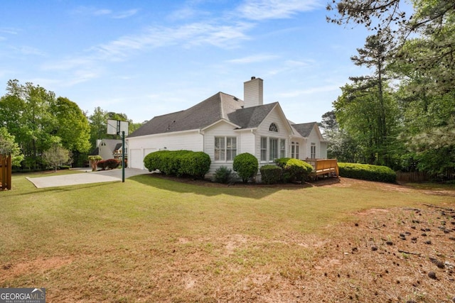 500 Meadowmeade Ln, Lawrenceville, GA 30043 - view of home's exterior featuring an attached garage, a chimney, a lawn, concrete driveway, and a deck