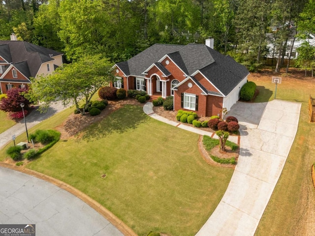 500 Meadowmeade Ln, Lawrenceville, GA 30043 - view of front of home featuring driveway, a front yard, brick siding, a shingled roof, and a garage