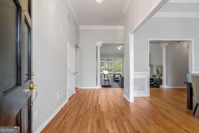 500 Meadowmeade Ln, Lawrenceville, GA 30043 - entryway with decorative columns, light wood-type flooring, crown molding, and ceiling fan