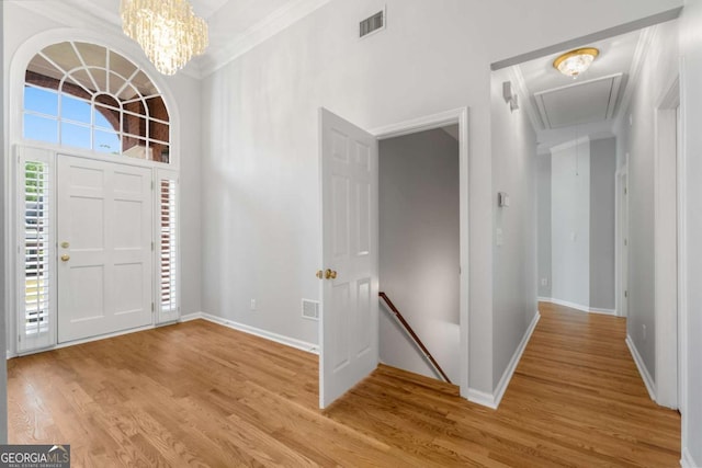 500 Meadowmeade Ln, Lawrenceville, GA 30043 - entrance foyer with light wood-style flooring, ornamental molding, and a chandelier