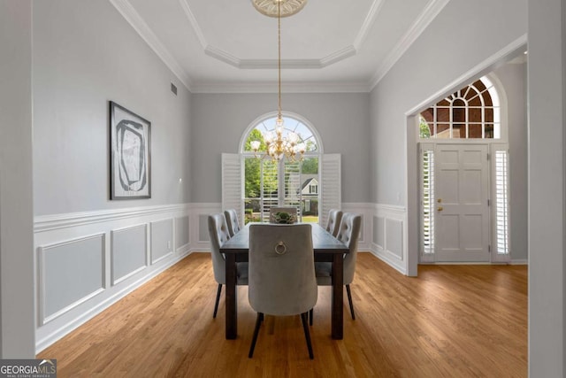 500 Meadowmeade Ln, Lawrenceville, GA 30043 - dining room with a chandelier, healthy amount of natural light, wood finished floors, a tray ceiling, and a decorative wall