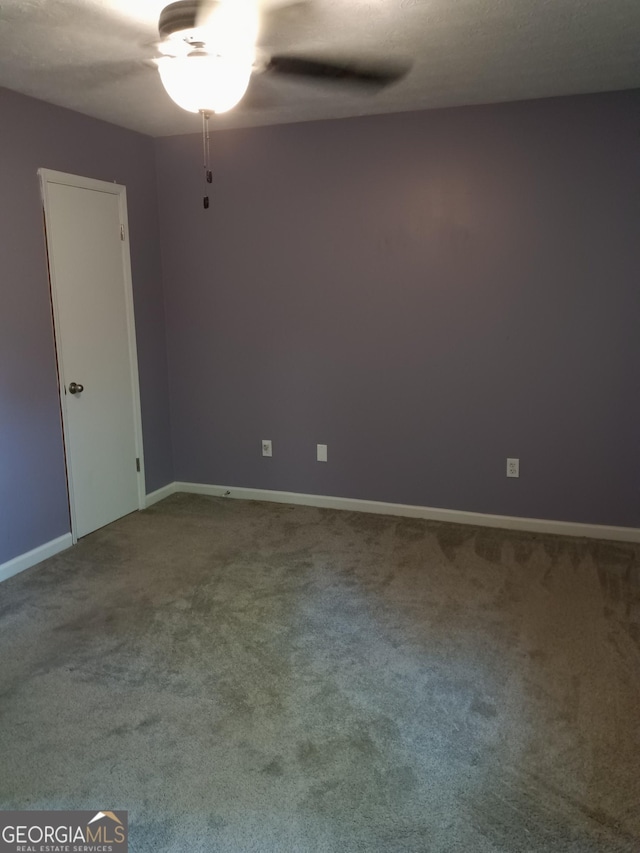 4616 Hamlet Walk SE, Conyers, GA 30094 - carpeted empty room featuring baseboards and a ceiling fan
