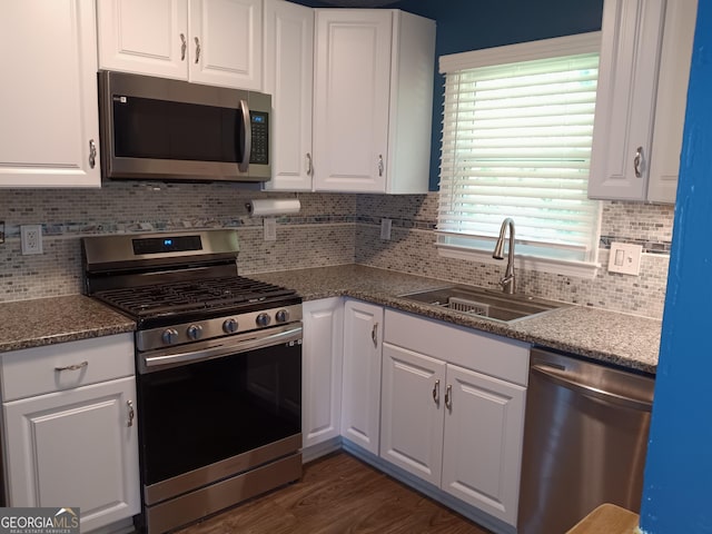 4616 Hamlet Walk SE, Conyers, GA 30094 - kitchen with stainless steel appliances, a sink, white cabinetry, and backsplash