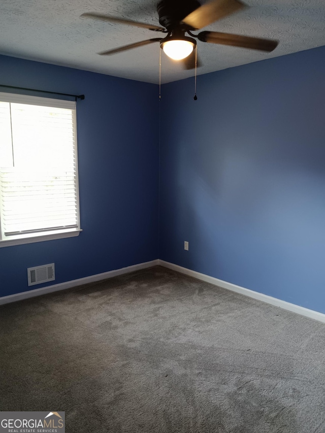 4616 Hamlet Walk SE, Conyers, GA 30094 - carpeted spare room with a ceiling fan, baseboards, and a textured ceiling