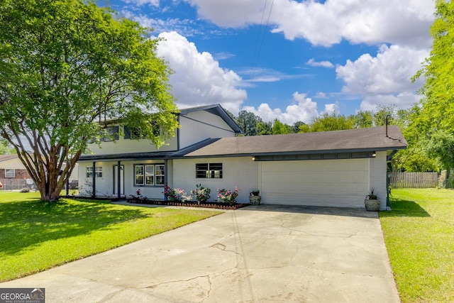 203 N Lake Dr, Brunswick, GA 31525 - traditional-style home with a front lawn, concrete driveway, fence, brick siding, and an attached garage