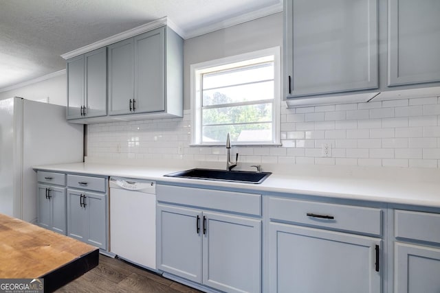 203 N Lake Dr, Brunswick, GA 31525 - kitchen with crown molding, tasteful backsplash, a sink, white appliances, and dark wood-type flooring