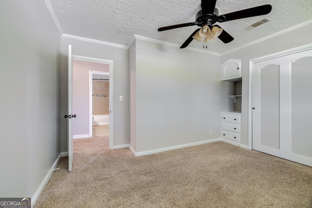 203 N Lake Dr, Brunswick, GA 31525 - unfurnished bedroom featuring a ceiling fan, a textured ceiling, light carpet, ornamental molding, and visible vents