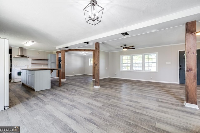 203 N Lake Dr, Brunswick, GA 31525 - unfurnished living room with baseboards, a healthy amount of sunlight, and light wood-style floors