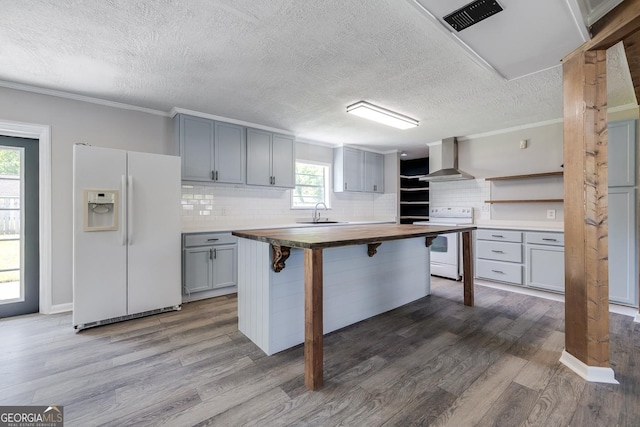 203 N Lake Dr, Brunswick, GA 31525 - kitchen with wall chimney range hood, white appliances, gray cabinetry, wood counters, and a textured ceiling