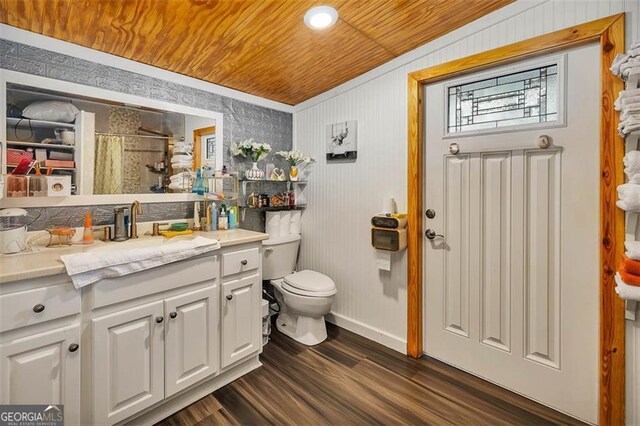 3682 Brantley Ave, Brunswick, GA 31520 - bathroom with wood finished floors, toilet, vanity, wooden ceiling, and baseboards