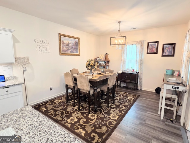 288 Mccall Way, Monroe, GA 30655 - dining space with an inviting chandelier, dark wood-style flooring, visible vents, and baseboards