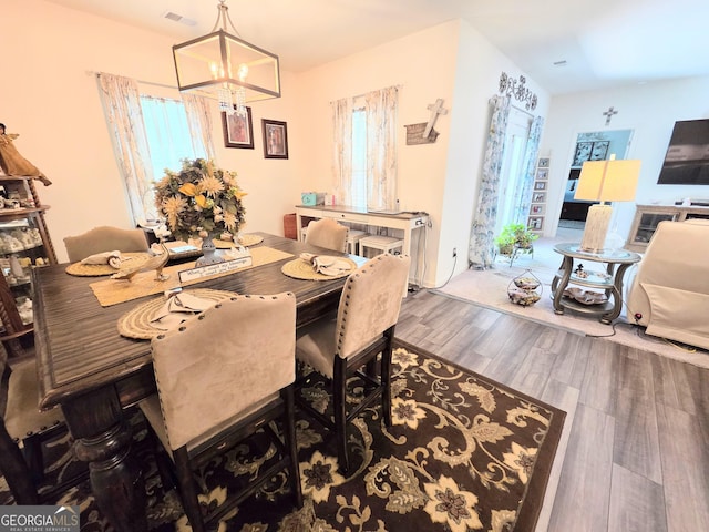 288 Mccall Way, Monroe, GA 30655 - dining area featuring a chandelier, wood finished floors, and visible vents