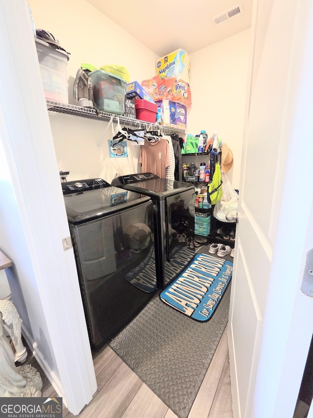 288 Mccall Way, Monroe, GA 30655 - clothes washing area with separate washer and dryer, visible vents, wood finished floors, and laundry area