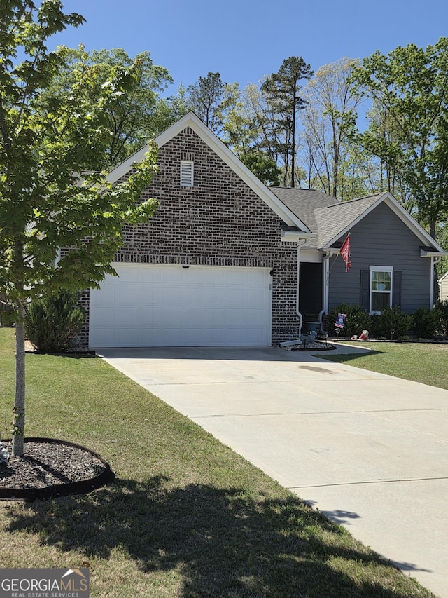288 Mccall Way, Monroe, GA 30655 - view of front of house featuring concrete driveway, a front lawn, brick siding, and a garage
