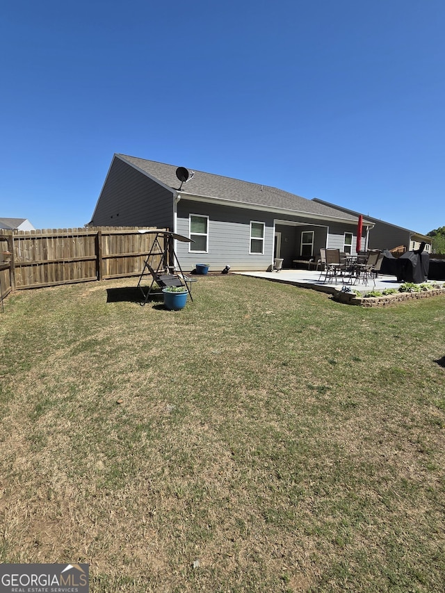 288 Mccall Way, Monroe, GA 30655 - back of property featuring fence, a patio area, and a lawn