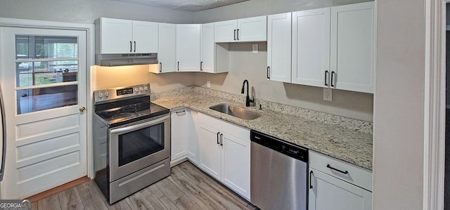 185 Johnson Dr, Athens, GA 30605 - kitchen with appliances with stainless steel finishes, under cabinet range hood, white cabinetry, and light wood-style floors