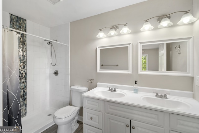 1825 SW Willis Mill Rd, Atlanta, GA 30311 - bathroom featuring a tile shower, double vanity, toilet, and a sink