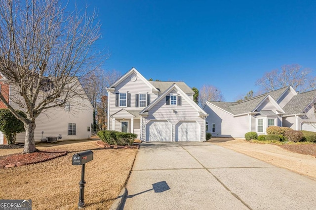 traditional home with a garage, cooling unit, and concrete driveway