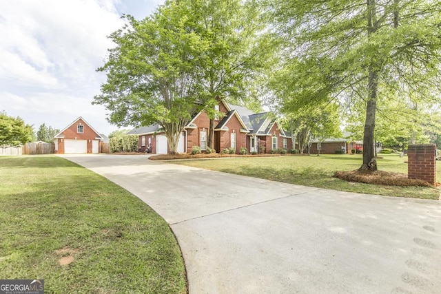 traditional home with concrete driveway, a front lawn, brick siding, and a detached garage