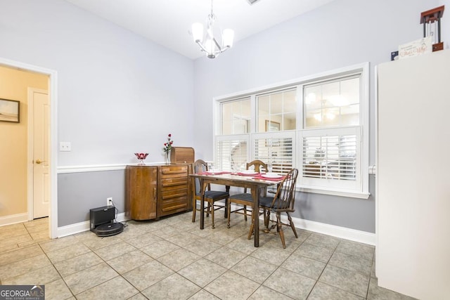 dining room with baseboards, a notable chandelier, and light tile patterned floors