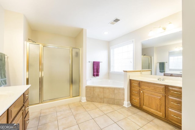 bathroom with a shower stall, tile patterned flooring, visible vents, a sink, and two vanities