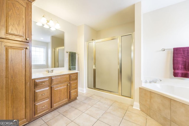 bathroom featuring a bath, a shower stall, tile patterned flooring, and vanity
