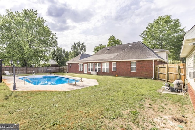 view of pool with a yard, a patio area, and a fenced backyard
