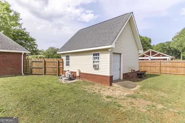exterior space with a fenced backyard, roof with shingles, and a lawn