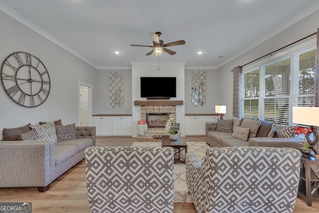 living room featuring a fireplace, light wood-style flooring, crown molding, and ceiling fan